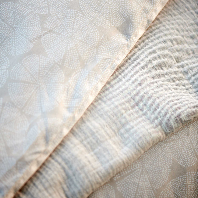 PURE 93 XL dekbedovertrekset | stone Pure 93 linen dekbedovertrek heeft een patroon met cirkels die uit partjes bestaan en gevormd worden door kleine witte stipjes op een beige achtergrond. De achterkant van het dekbedovertrek heeft hetzelfde patroon. De kussens hebben ook aan allebei de kanten hetzelfde patroon.