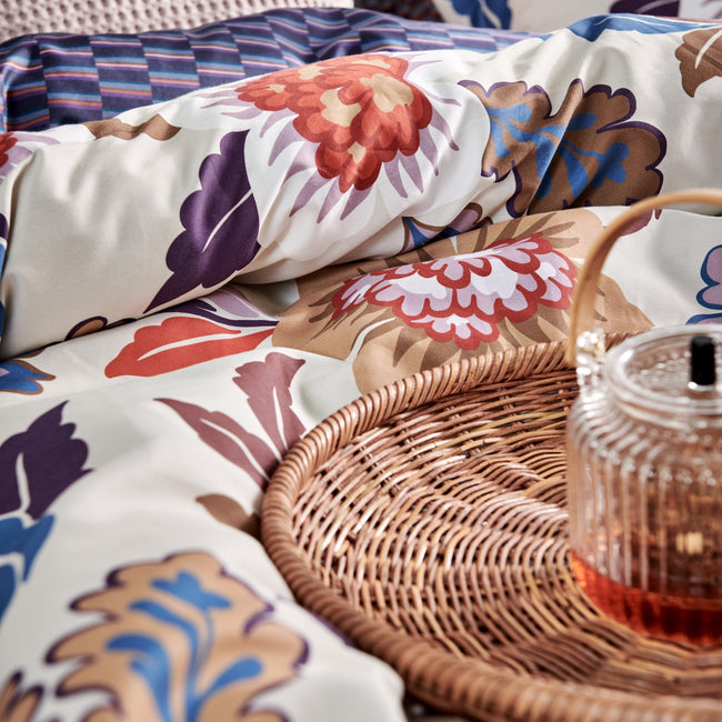 GRAPHIC dekbedovertrekset | multi detail shot van een dekbedovertrek met een grafische print in rode en blauwe kleuren en een dekbedovertrek met bloemen in blauw en rode kleuren