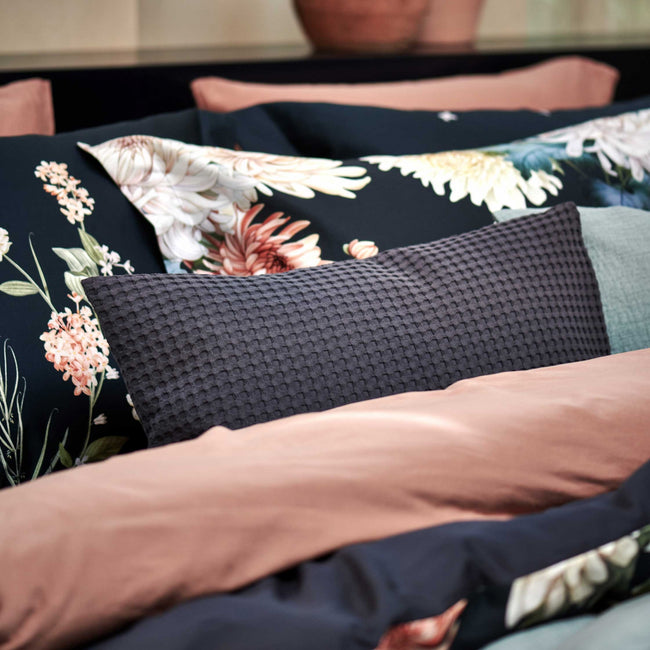 FLORAL BLISS dekbedovertrekset | blue ink detail shot van een bed met daarop een sierkussen in een blauwe kleur en een dekbedovertrek in een blauwe kleur met bloemen