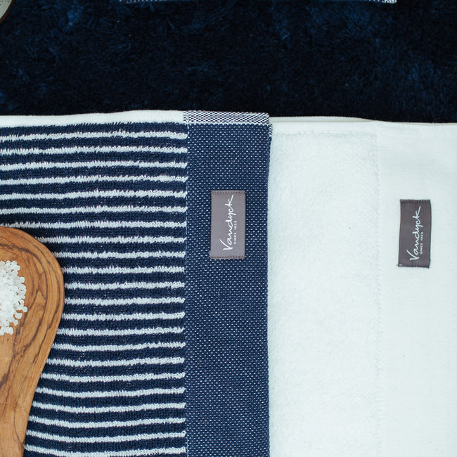 detail shot van een handdoeken met witte en blauwe strepen en een witte handdoek