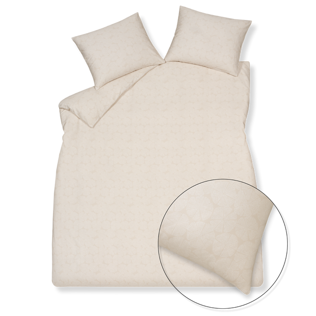 Pure 93 linen dekbedovertrek heeft een patroon met cirkels die uit partjes bestaan en gevormd worden door kleine witte stipjes op een beige achtergrond. De achterkant van het dekbedovertrek heeft hetzelfde patroon. De kussens hebben ook aan allebei de kanten hetzelfde patroon.