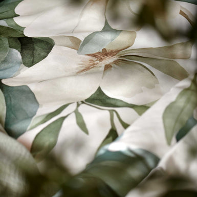 detail shot van een dekbedovertrek met groene en gele bloemen en groene bladeren