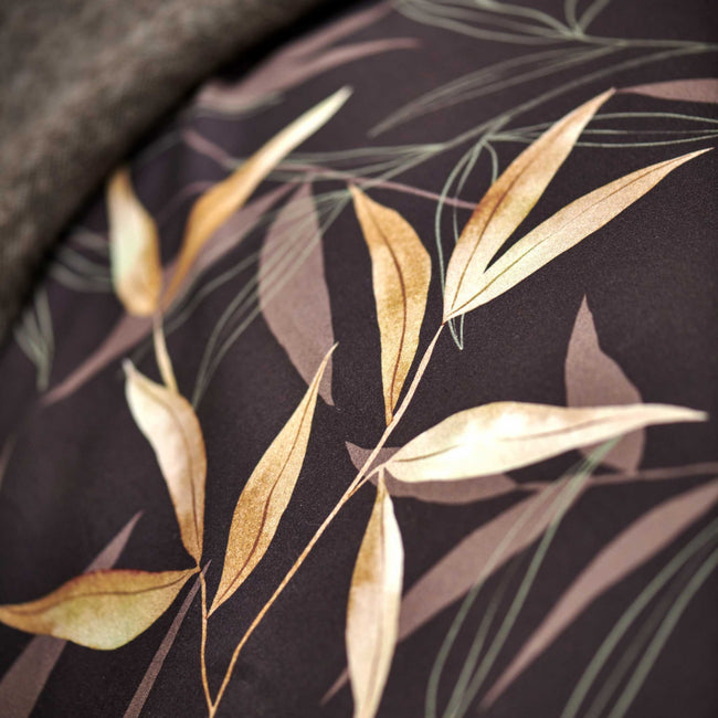 detail shot van een bruin dekbedovertrek met bamboe takken